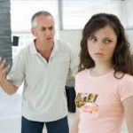 frustrated father talking at teen