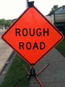 road sign saying rough road